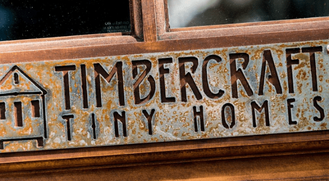 Timbercraft Tiny Homes logo emblazened in a door